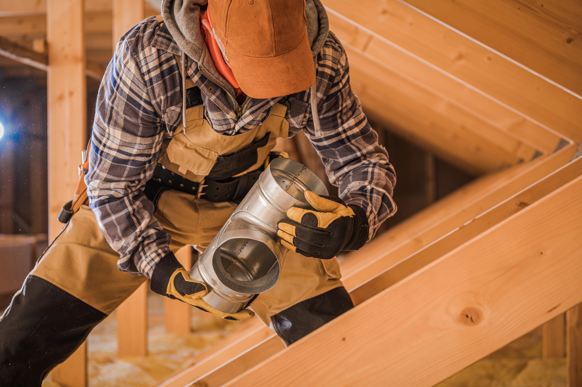 Air Duct Cleaning Service Near Boonsboro & Peakland: technician inspects duct fitting in attic