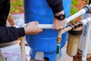 Plumber services well pump system, a factor in water heater replacement cost