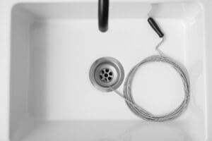 Drain snake in a sink — snake your own drain or call a plumber