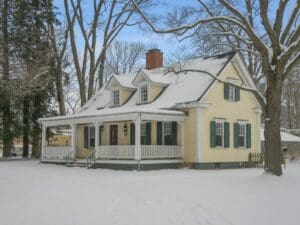 Best heating systems for older homes in Forest VA with snow-covered yellow historic house