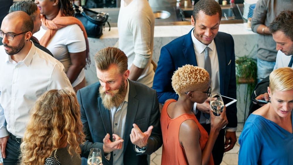 Local business professionals networking at a Halifax community event